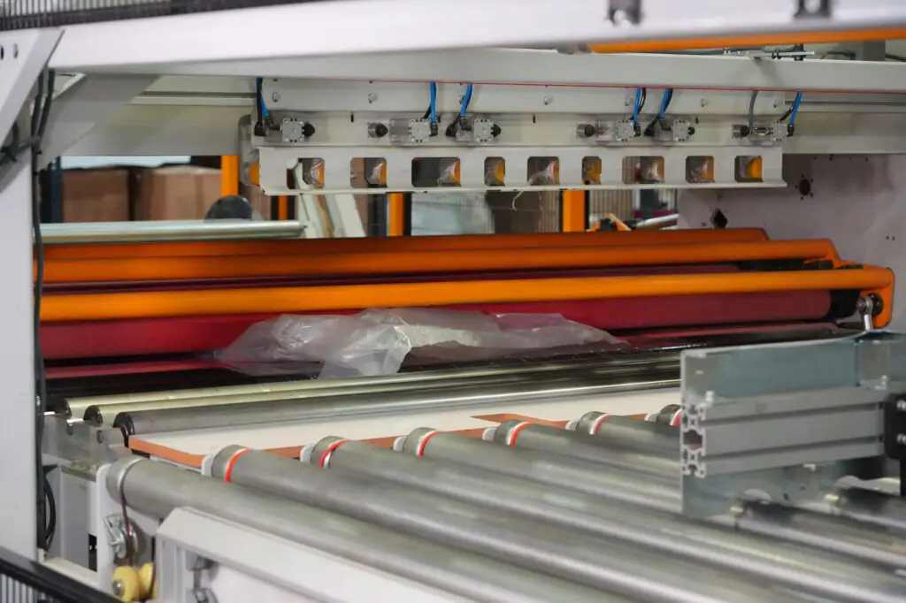 Close-up of automated precision cutting machinery inside the HLJ Foam fabrication plant.