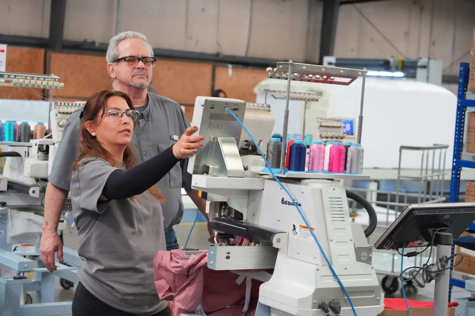 Two HLJ Foam engineers inspecting a custom CNC-cut foam prototype inside the production facility.