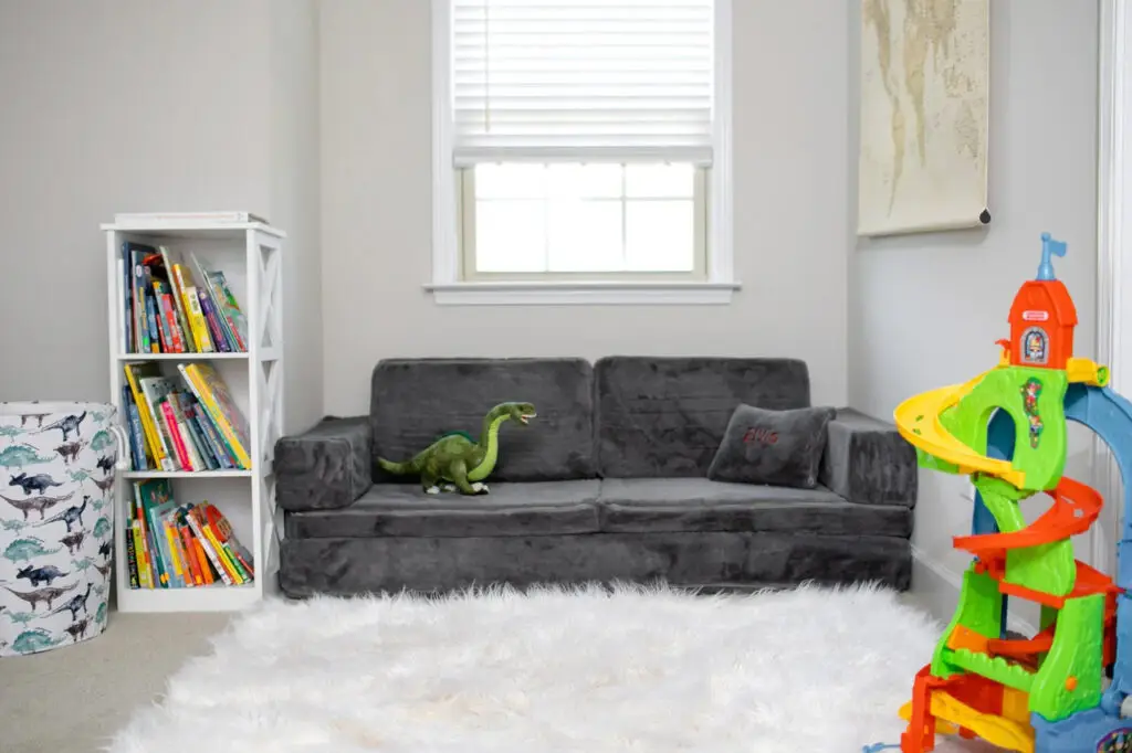 Dark grey modular foam sofa and cushions styled in a modern living room setting.