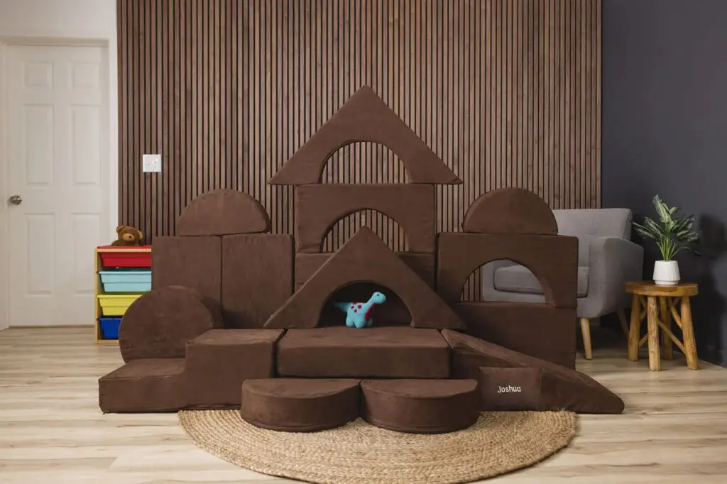 Brown FoamOh™ Super Castle modular foam play couch set built in a castle structure.